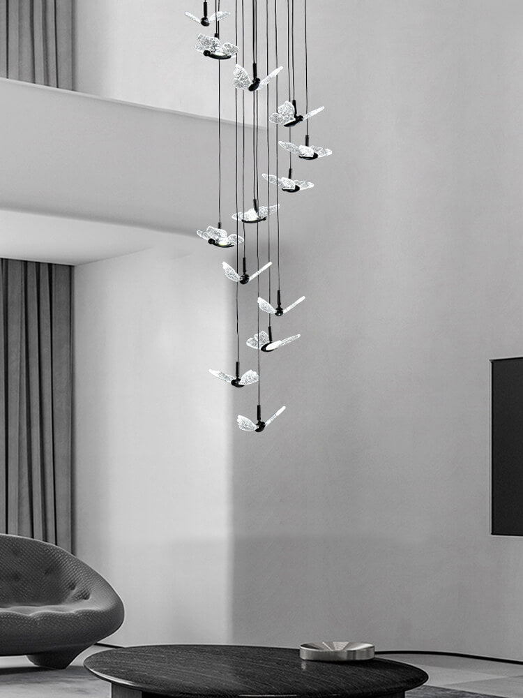 smoke grey crystal butterfly pendant lighting hanging over a sofa in the living room