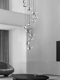 smoke grey crystal butterfly pendant lighting hanging over a sofa in the living room