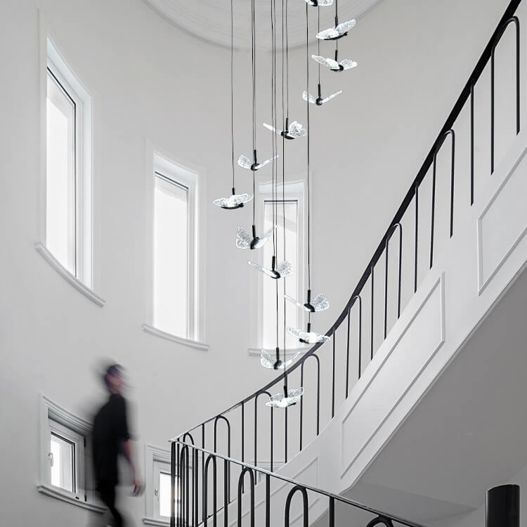 smoke grey crystal butterfly pendant lighting hanging from the ceiling in the staircase