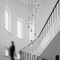 smoke grey crystal butterfly pendant lighting hanging from the ceiling in the staircase