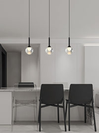 glass globe pendant lighting hanging over a rectangle table