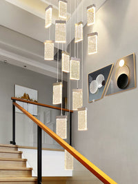square crystal bubble pendant light hanging from ceiling besides staircase
