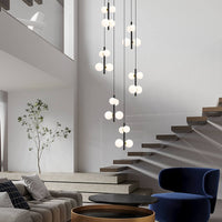multi opal globe pendant lighting hanging over the round table in the living room