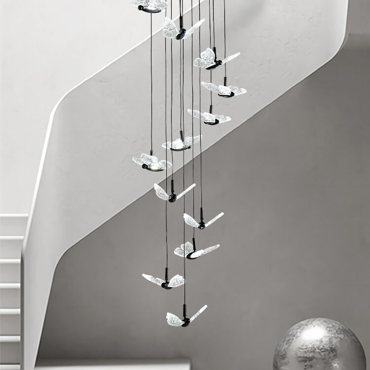 smoke grey crystal butterfly pendant lighting hanging from the ceiling in the staircase