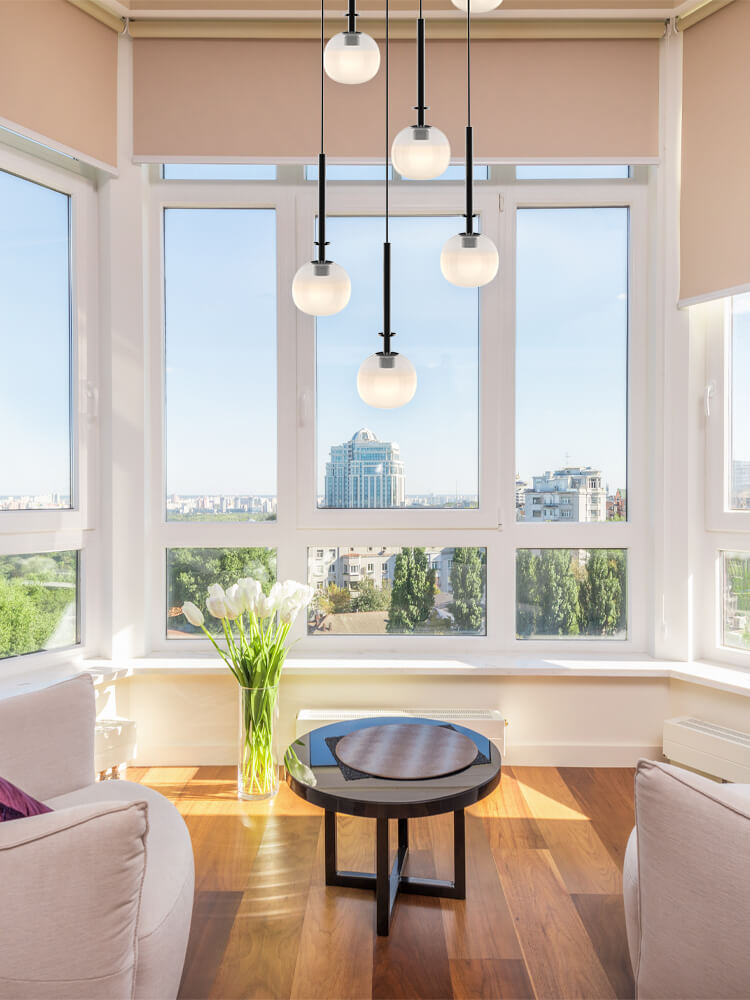 Aurorae’s pendant light in a modern living room, its creamy glow creating a haven of sophistication.