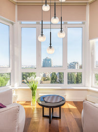 Aurorae’s pendant light in a modern living room, its creamy glow creating a haven of sophistication.