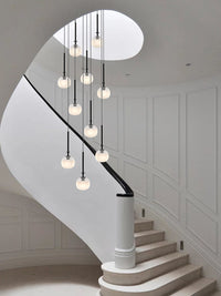 multi cream glass globe pendant lighting is hanging for staircase