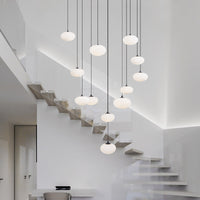 multi milk ball chandelier in Nordic style is hanging from ceiling besides staircase