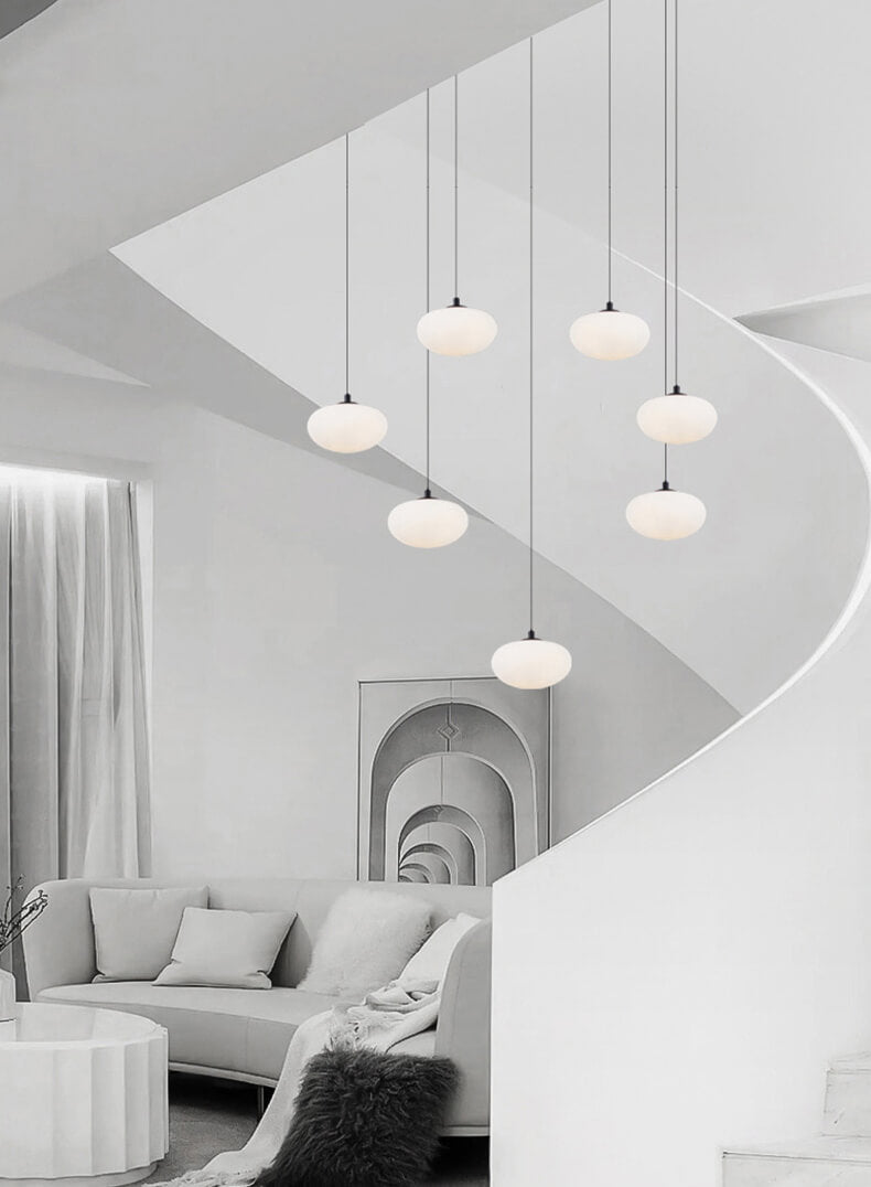 multi milk ball chandelier in Nordic style is hanging from ceiling besides a spiral staircase in the loft